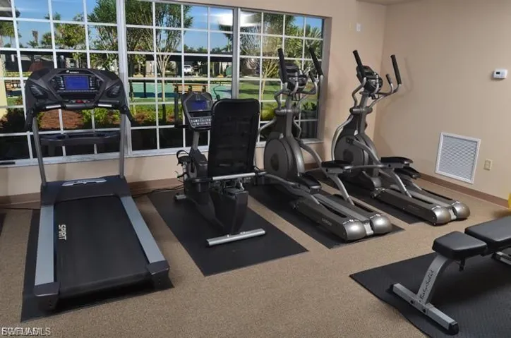 Workout area featuring baseboards and carpet