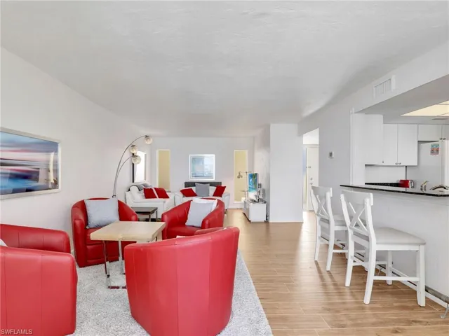 Living room with light wood finished floors and baseboards