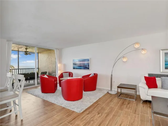 Living room with wood finished floors and expansive windows
