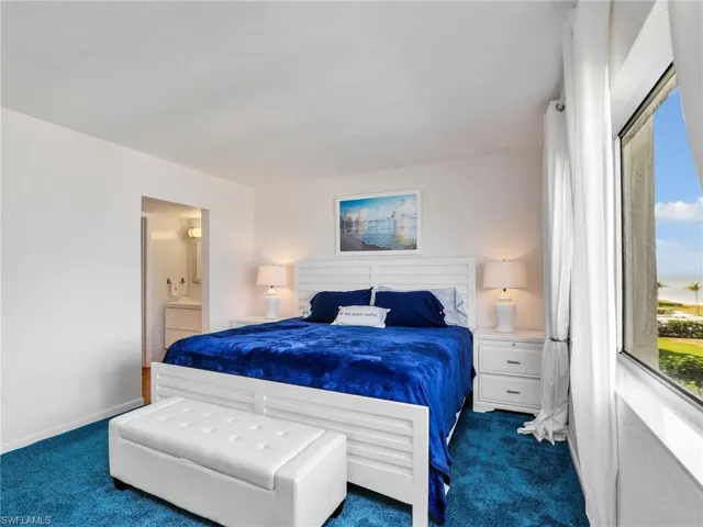 Bedroom featuring carpet floors and ensuite bathroom