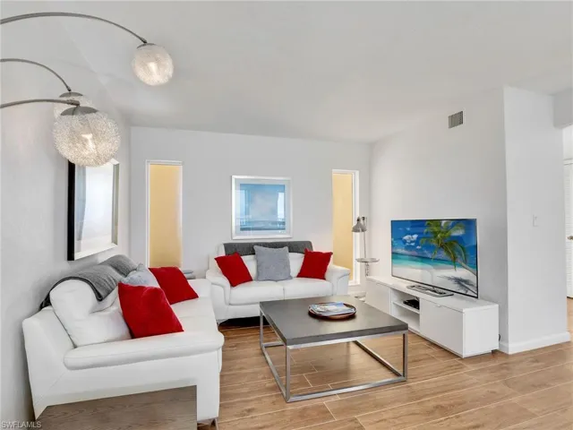 Living room with light wood-style flooring and baseboards