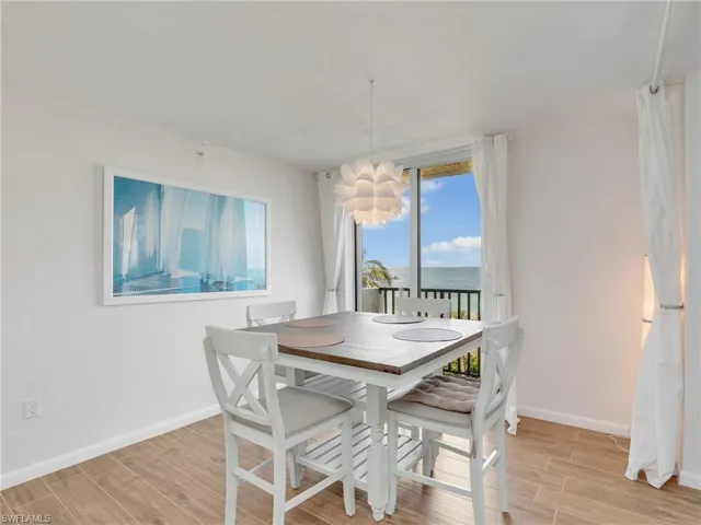 Dining space with light wood-type flooring and a water view