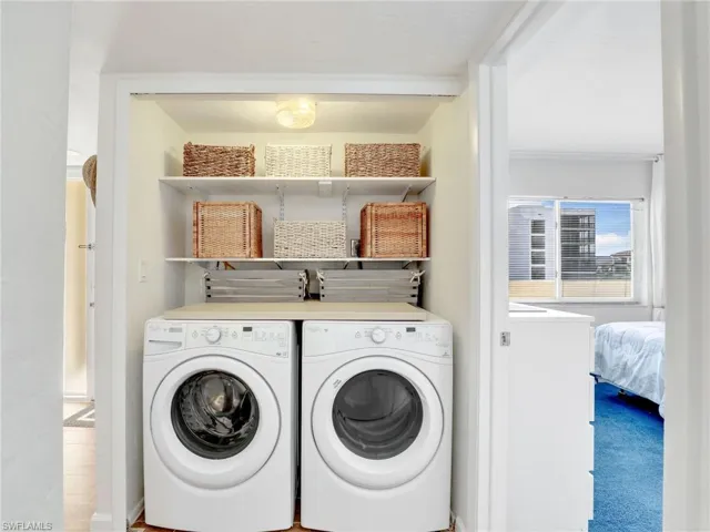 Laundry area with separate washer and dryer and baseboards