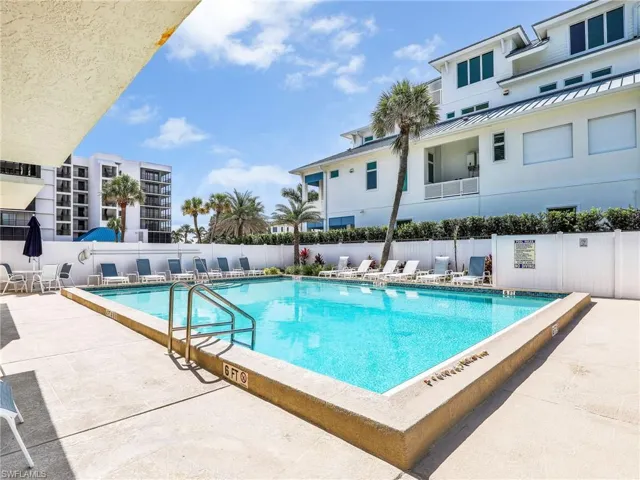 Community pool with a patio