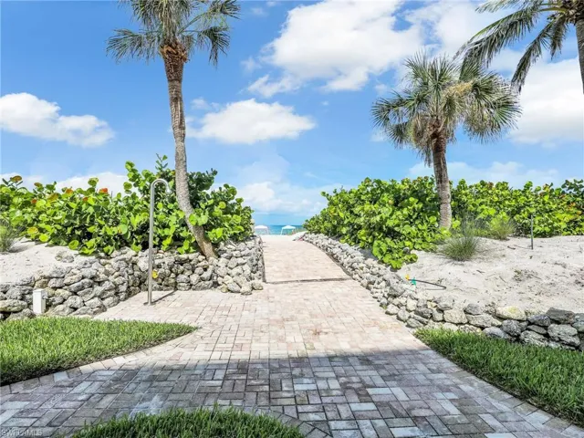 View of property's community featuring view of water and beach