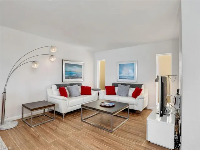 Living area with light wood-style floors and baseboards