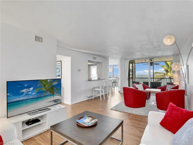 Living area featuring wood finished floors and floor to ceiling windows