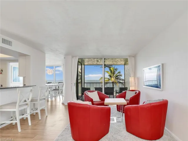 Living room with a wall of windows and wood finished floors