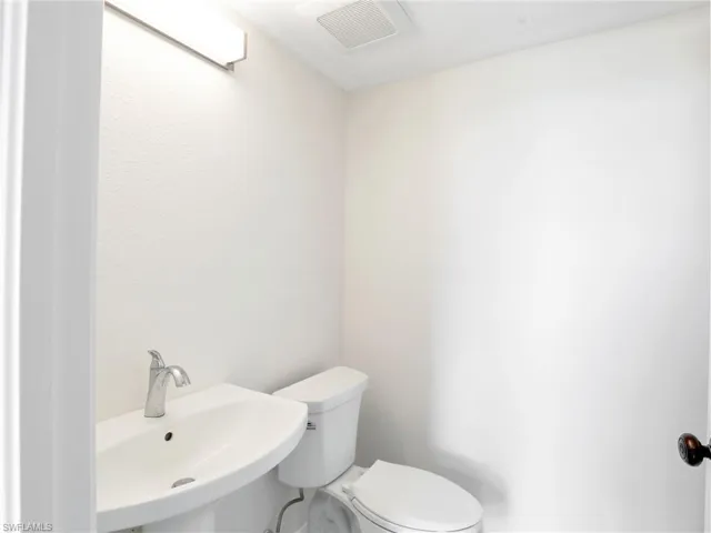 Half bathroom with toilet and a sink
