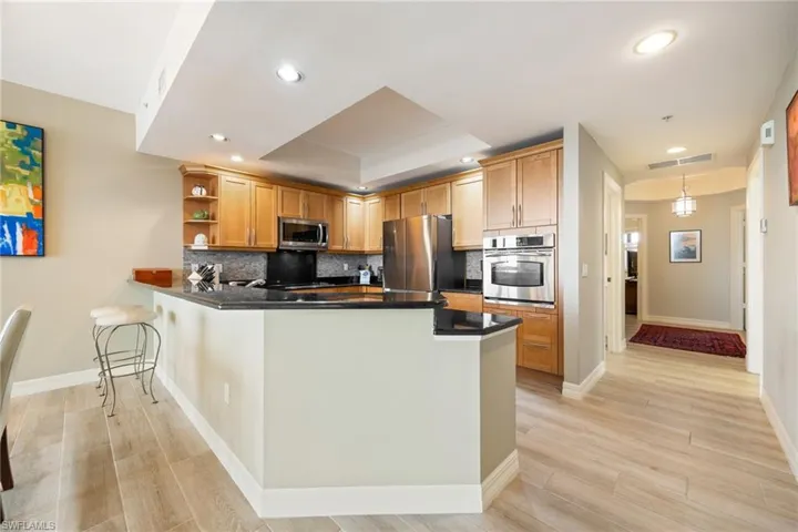Kitchen with open shelves, High-end stainless steel appliances.