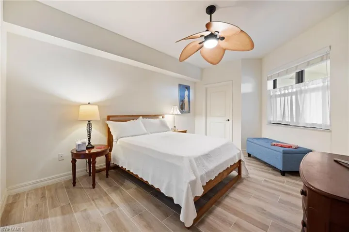 Guest Bedroom with ensuite.  Wood-like tiled floors and ceiling fan.