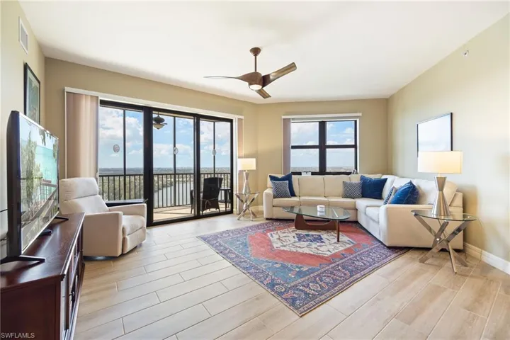 Living room featuring a ceiling fan and wood-like tile floors throughout.