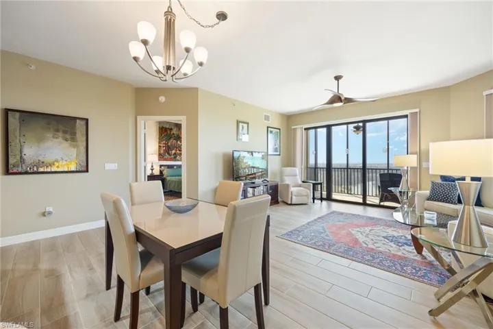 Dining space featuring wood-like tile flooring and view out to the lanai.
