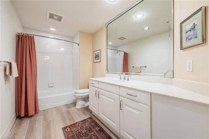 2nd Full bath featuring vanity, shower / tub combo with white tile, recessed lighting, and wood-like tile floors