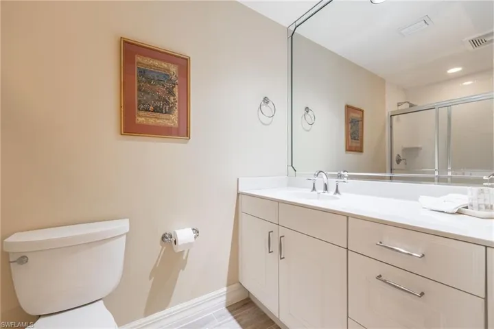 Full bath featuring vanity, an enclosed shower, and recessed lighting