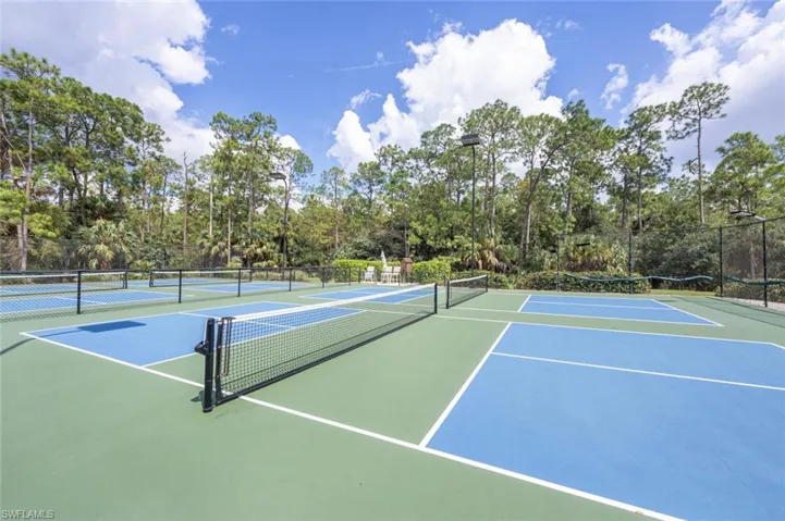 View of tennis court with basketball hoop