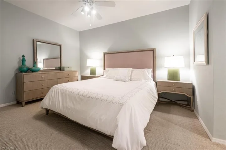 Carpeted bedroom with ceiling fan