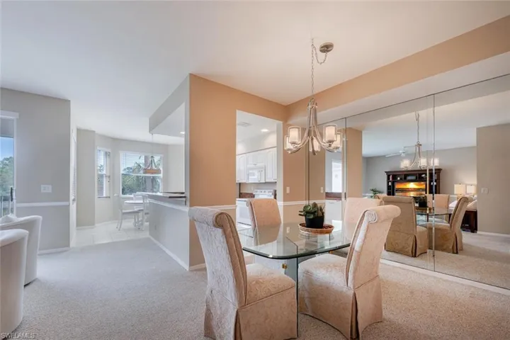 Dining area featuring light colored carpet