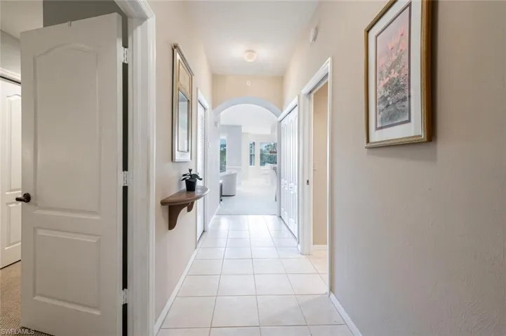 Corridor with light tile patterned flooring