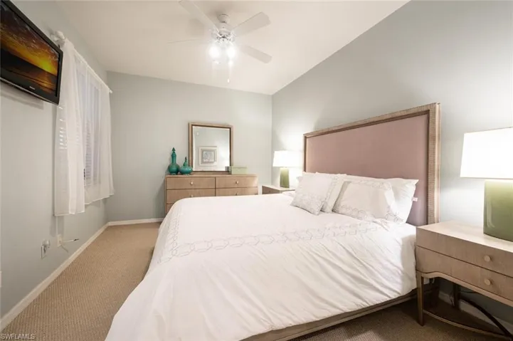 Carpeted bedroom with ceiling fan