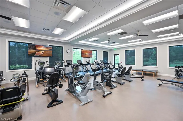 Exercise room featuring a drop ceiling and ceiling fan