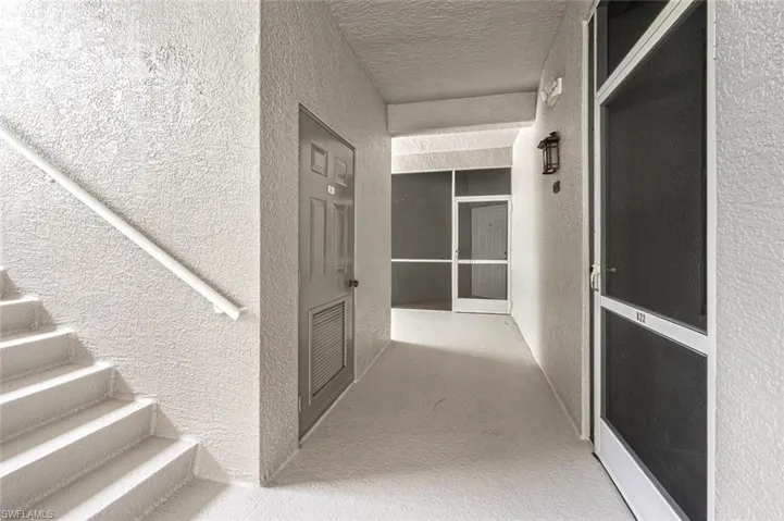 Hallway with carpet and a textured ceiling