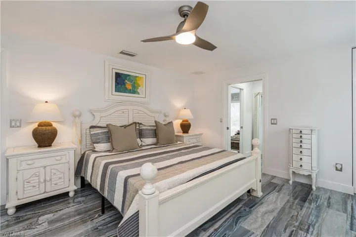 Bedroom with baseboards, ceiling fan, and visible vents