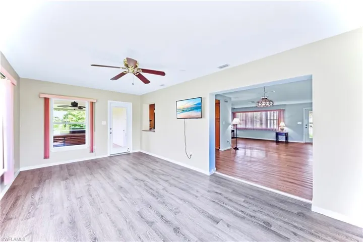 Unfurnished living room featuring ceiling fan and hardwood / wood-style floors
