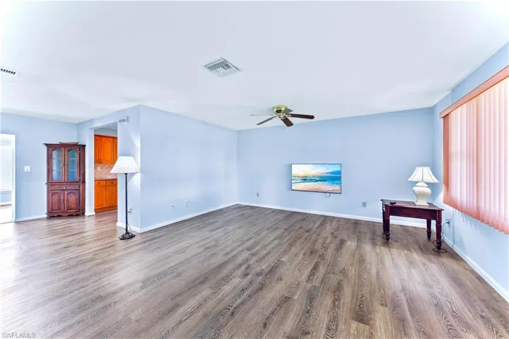 Unfurnished living room with hardwood / wood-style flooring and ceiling fan