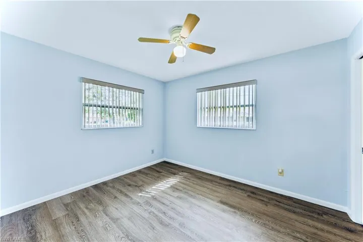 Empty room featuring wood-type flooring and ceiling fan