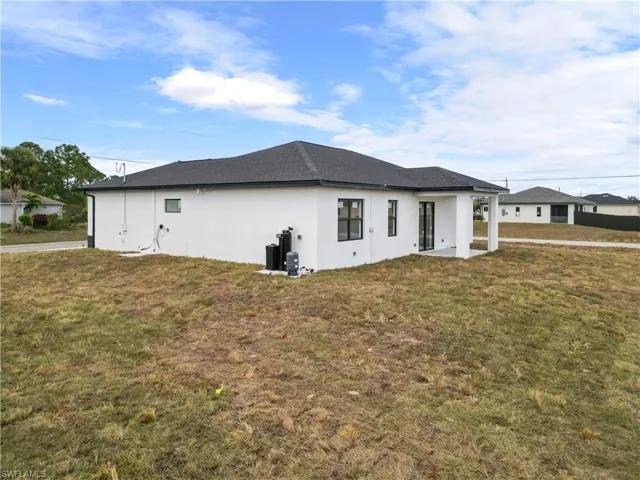 View of side of property featuring a lawn