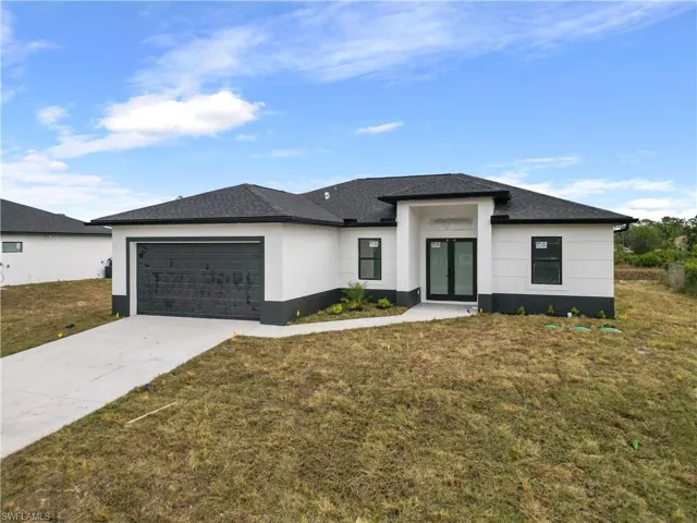 Prairie-style house with a front yard and a garage