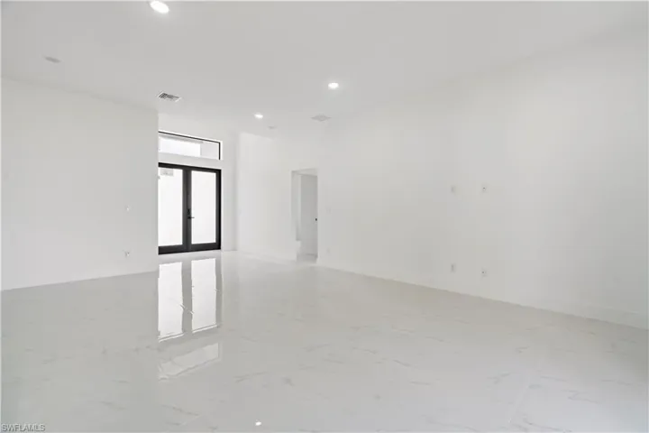 Unfurnished room featuring french doors