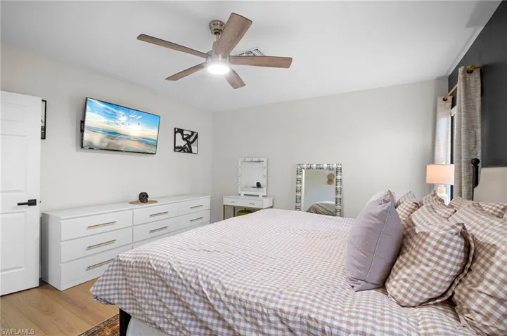 Bedroom with light wood-style flooring and a ceiling fan