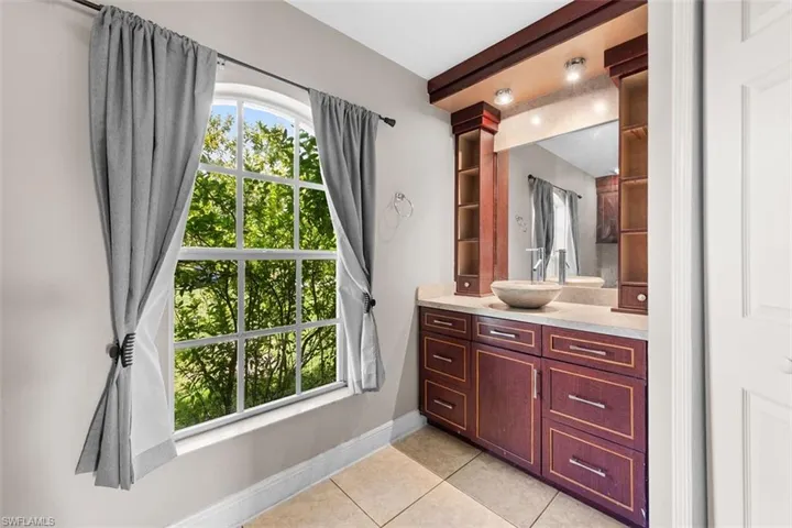 Bathroom featuring light tile patterned floors and vanity