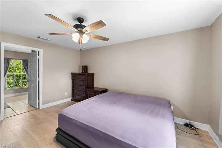 Bedroom with light wood finished floors and ceiling fan