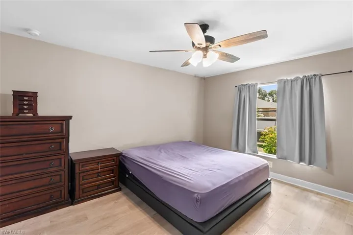 Bedroom with light wood finished floors and a ceiling fan