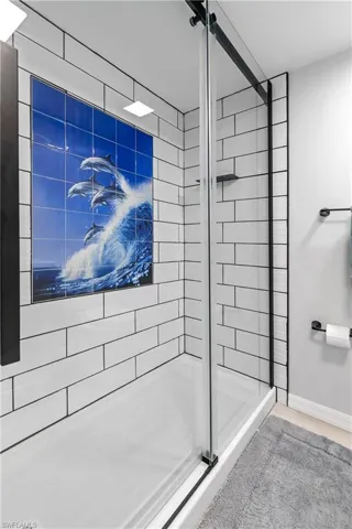 SECOND BATHROOM mirrors the ELEGANT DESIGN of the master bath, with WHITE & BLACK ACCENTS for striking contrast!