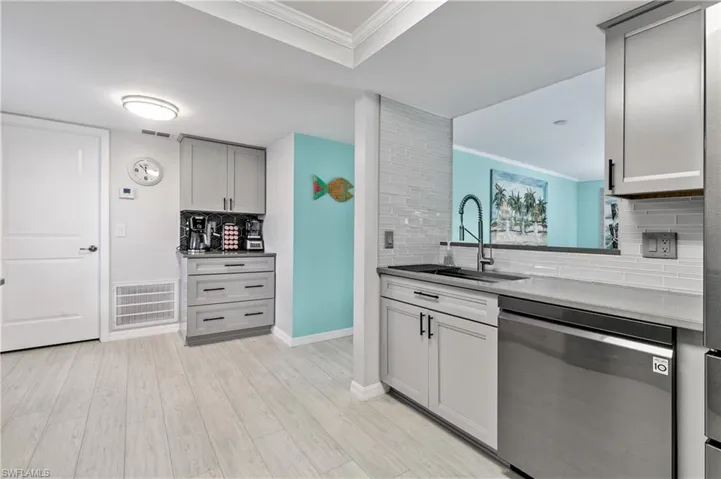 Large farmhouse sink, chrome pull-down spring spout faucet, and a chic decorative tile backsplash. Additional BAR/COFFEE NOOK make this kitchen AS FUNCTIONAL AS IT IS BEAUTIFUL!
