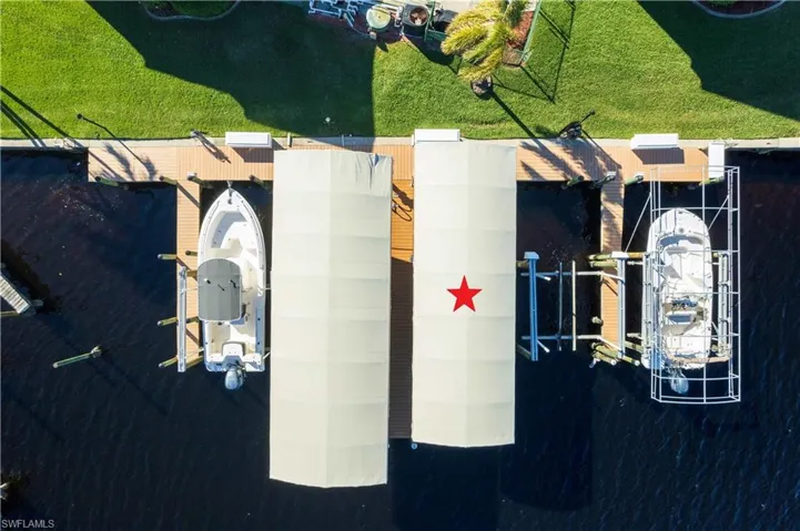 Located in SALTWATER CANAL w/ 200+ FEET OF WATER FRONTAGE, this HOME is just STEPS from YOUR PRIVATE BOAT DOCK, featuring 10K lb LIFT & CANOPY (2022), MAKING IT A DREAM COME TRUE for BOATING ENTHUSIASTS!