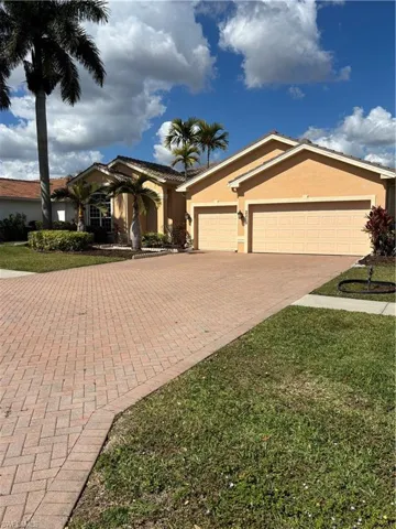 3 car garage with oversized paved driveway