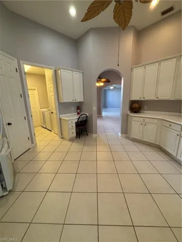 arched walkways to the formal dining room and formal living room