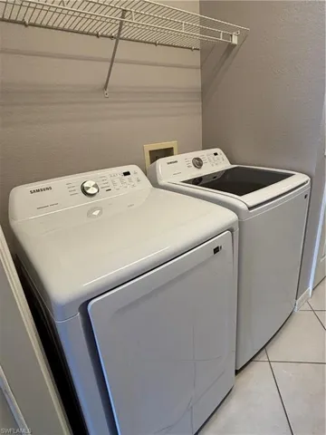 New Washer And New Dryer.  Laundry room also features a rack above, cabinets on the opposite wall and a utility closet.