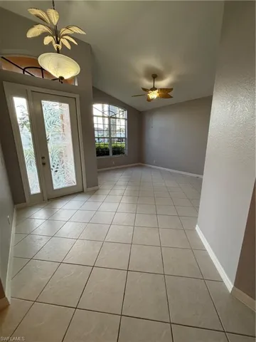 Entrance foyer with etched glass design doors leading into the formal living room