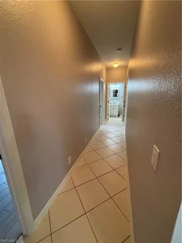 Split bedroom hallway with a full bathroom at each end