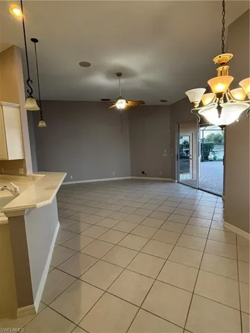 Breakfast dining area featuring a ceiling fan, and chandelier.  Also a Breakfast bar and view into the Family room area of this great room