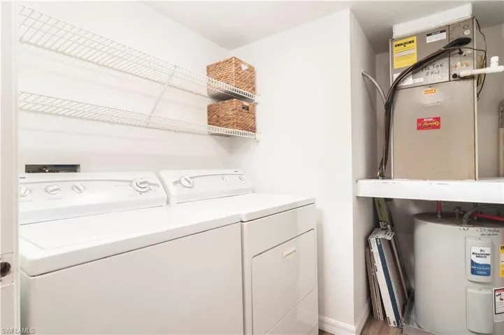 Laundry area featuring water heater and washing machine and dryer