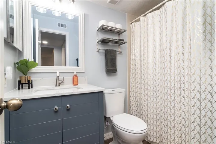 Full bath featuring vanity and a shower with shower curtain