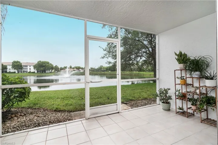 Sunroom featuring a water view and plenty of natural light