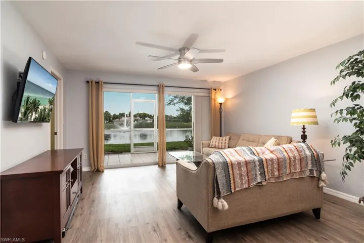 Bedroom with access to outside, light wood-type flooring, and ceiling fan